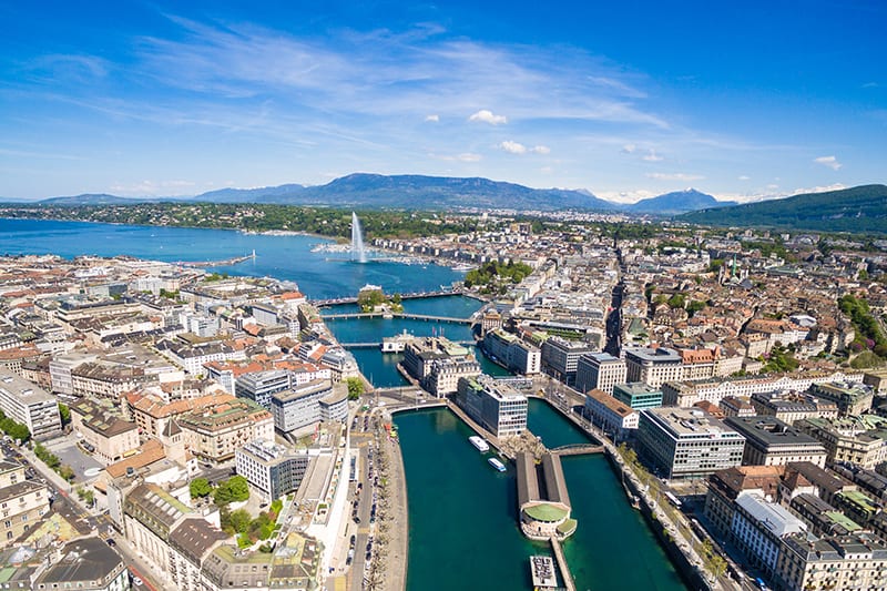 image is Aerial view of Lac Léman - Geneva city in Switzerland, Caption reads: This is Geneva, to which I was introduced by friends living there. I found it fascinating -- the financial action, the thousands of diplomats, the tourists from everywhere, the sheer beauty of the place. | Photo credit: iStock.com/sam74100