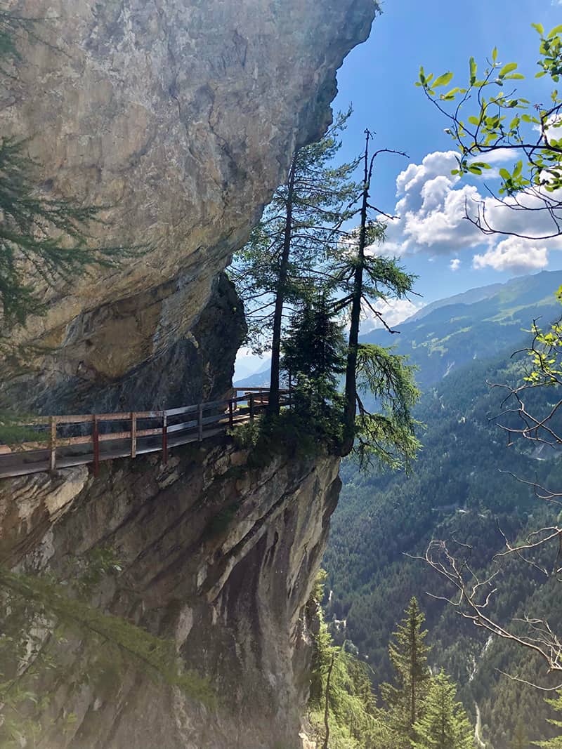 Image of a precarious wooden walkway around a cliff in Bisse du Ro, Switzerland | credit: pngdir